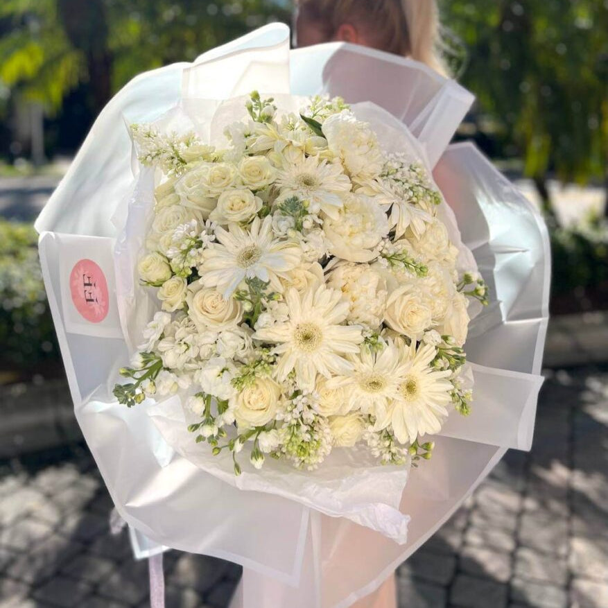 Elegant bouquet with white peonies, roses and daisies in designer wrapping — luxury flower gift Miami